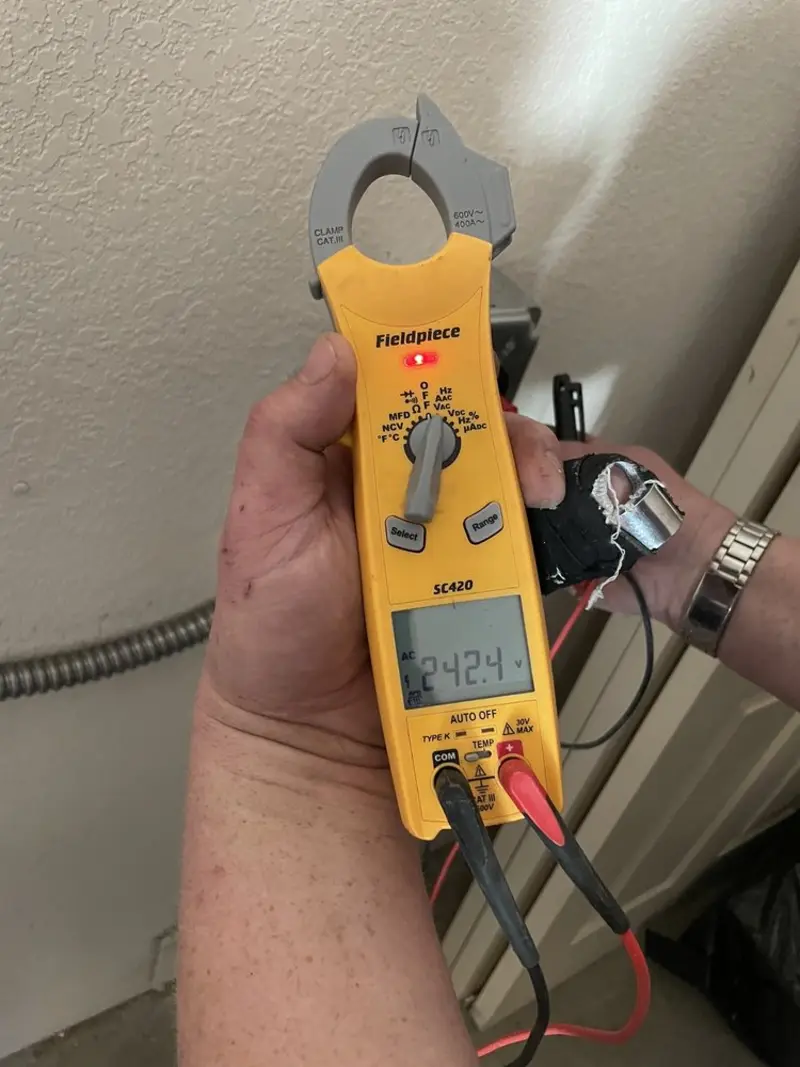 Voltage testing with clamp meter during Recessed Lighting Installation in Citrus Park